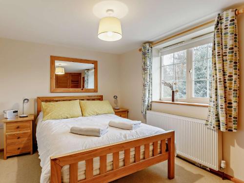 a bedroom with a large bed and a window at 1 Bed in Sidmouth HAYES in Newton Poppleford