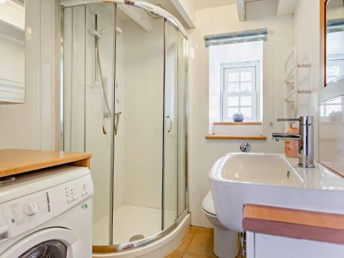 a bathroom with a shower and a toilet and a sink at 3 bed in Helmsdale SU192 in Helmsdale