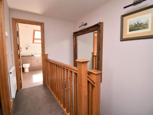 a staircase leading to a bathroom with a mirror at 3 Bed in Ironbridge HWLOC in Buildwas