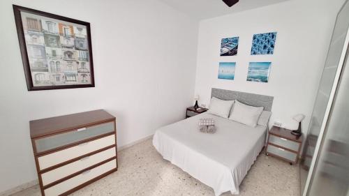 a white bedroom with a bed and a dresser at APARTAMENTO CÁDIZ TERRAZA - Pleno Casco Histórico in Cádiz