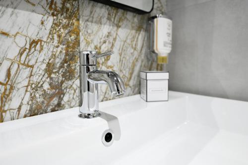 a bathroom sink with a chrome faucet at Hotel Arya by Mauro in Sirmione
