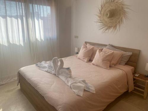 a bedroom with a large bed with towels on it at Bel appart wifi balcon et parking Marrakech centre in Marrakesh