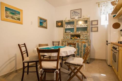 a kitchen with a table and chairs in a room at Holiday Home ART - Bol in Bol