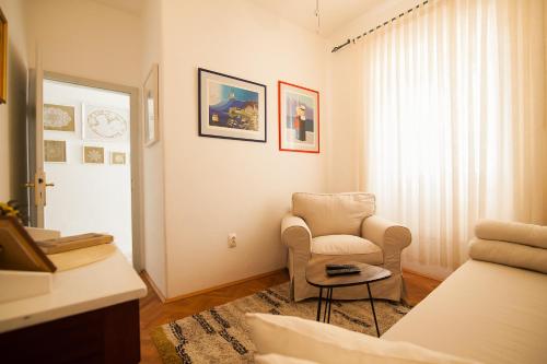 a living room with a chair and a table at Holiday Home ART - Bol in Bol