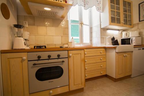 a kitchen with a stove and a window in it at Holiday Home ART - Bol in Bol
