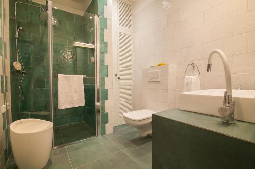 a bathroom with a toilet and a sink and a shower at Holiday Home ART - Bol in Bol