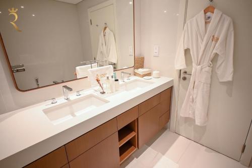 a bathroom with a sink and a mirror at 1BR Loft Soul Beach Escape - Mamsha Al Saadiyat in Abu Dhabi