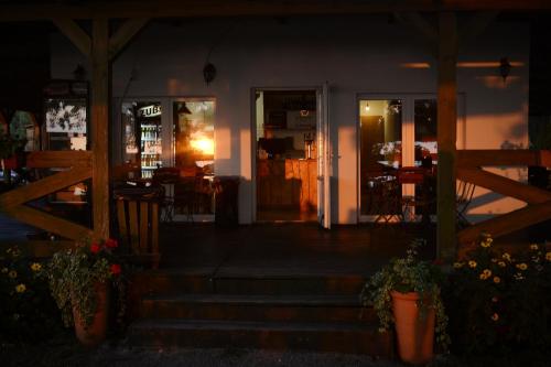 an open door of a restaurant at night at Camping Szczecinek Domy Wypoczynkowe in Szczecinek