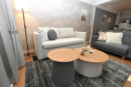 a living room with a table and a couch at ゆったり1LDKで最大8人まで宿泊可能！博多駅・キャナルも徒歩圏内！コンビニ・スーパー徒歩１分！ in Sumiyoshi