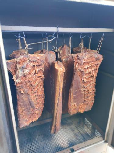 a bunch of meat hanging on a rack at Bauernhof Sonnenhuab in Sankt Veit im Pongau