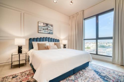 a bedroom with a large bed and a large window at Rahaal 2, Madinat Jumeirah Living, Umm Suqeim - Mint Stay in Dubai