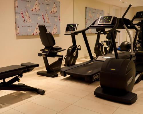 a gym with several exercise bikes in a room at SeeHuus Lifestyle Hotel in Timmendorfer Strand