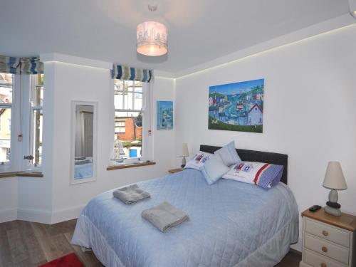 a bedroom with a bed with two pillows on it at 3 Bed in Brixham BX078 in Brixham