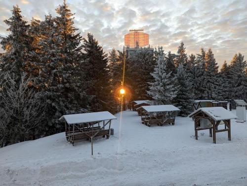 a group of picnic tables in the snow at Auersberg Haus in Eibenstock