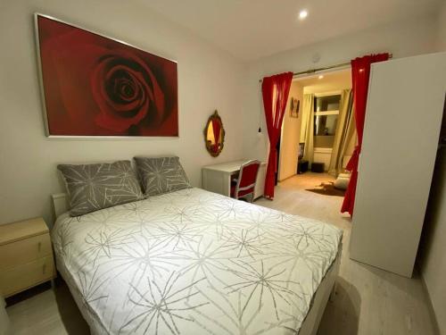 a bedroom with a bed and a red painting on the wall at Antwerp City apartment 3 in Antwerp