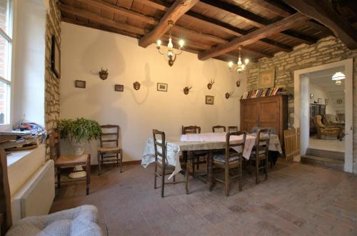 a kitchen and dining room with a table and chairs at Saint-malachie in Longchamp-sur-Aujon