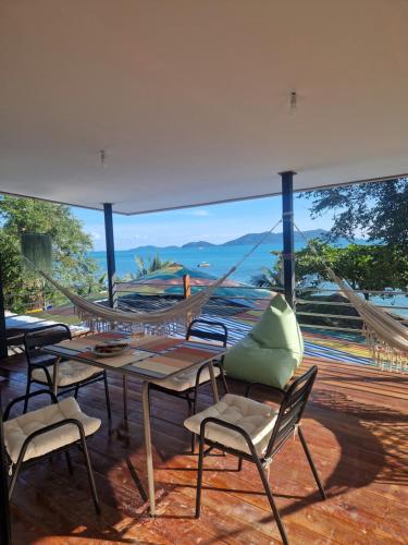 a patio with a hammock and a table and chairs at Little Monkey in Ko Chang