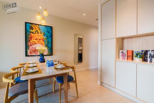 a dining room with a table and chairs at Son&Henry Zenity District 1 in Ho Chi Minh City