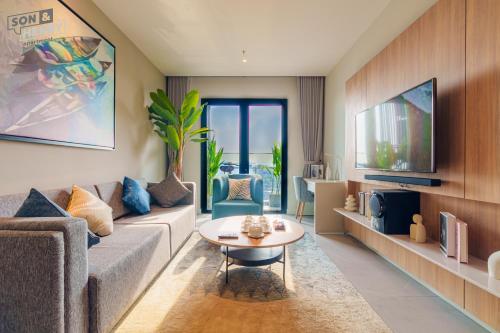 a living room with a couch and a table at Son&Henry Zenity District 1 in Ho Chi Minh City