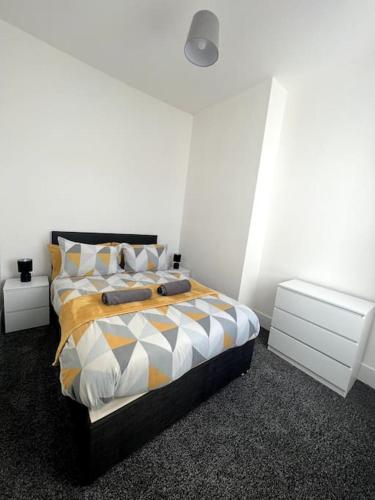 a bedroom with a bed and two night stands at No. 51 - Modern 4 bed in Liverpool