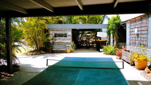 a ping pong table in the middle of a patio at Backpackers at 1770 in Agnes Water