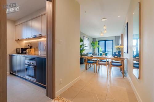 a kitchen and dining room with a table and chairs at Son&Henry Zenity District 1 in Ho Chi Minh City