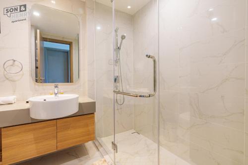a bathroom with a sink and a shower at Son&Henry Zenity District 1 in Ho Chi Minh City