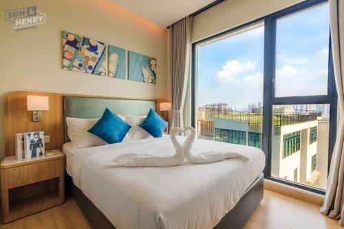 a bedroom with a bed with a large window at Son&Henry Zenity District 1 in Ho Chi Minh City