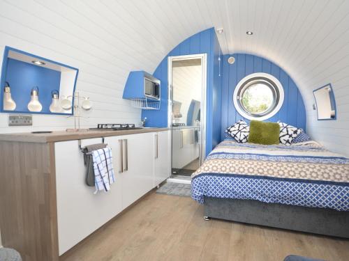 a blue and white room with a bed and a sink at 1 Bed in St Davids 62569 in Abercastle