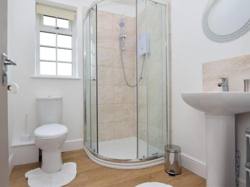 a bathroom with a shower and a toilet and a sink at 2 Bed in Stokesley 75544 in Stokesley