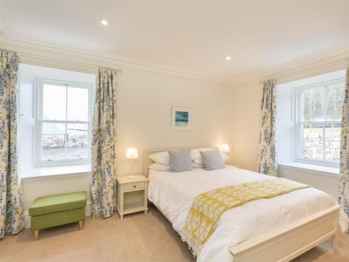 a bedroom with a bed and two windows at 6 Bed in Applecross CA343 in Applecross