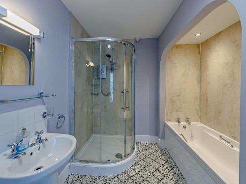 a bathroom with a shower and a sink and a tub at 2 Bed in Bude 75046 in Kilkhampton