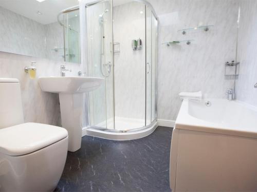 a bathroom with a shower and a toilet and a sink at 1 Bed in Howden G0181 in Saltmarshe