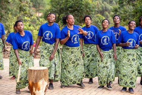a group of women in blue shirts posing for a picture at Gorilla Leisure Lodge in Kisoro