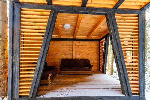 a couch sitting in the inside of a wooden house at Шишка in Bukovel
