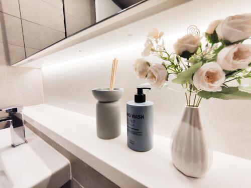 a white counter with flowers and a bottle of sunscreen at French Country Style in Olympic Park in Sydney