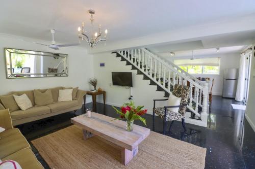 a living room with a couch and a table at Chateau Elysium - Two bedroom villa 1 in Beau Vallon
