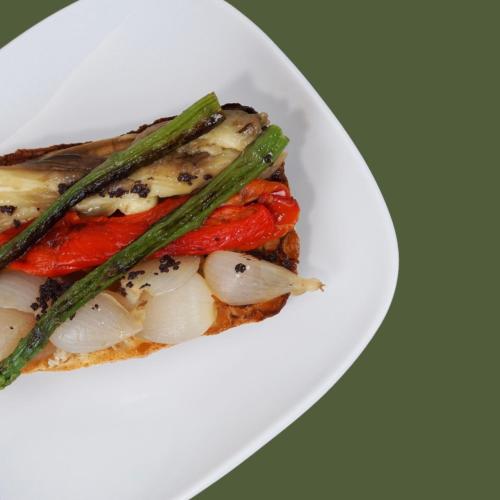 a plate of food with vegetables on a plate at HOTEL LA PERLA in Olot