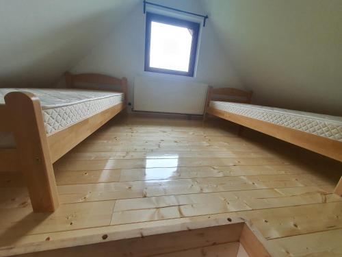 a room with two bunk beds and a window at Dzemper Cottage House in Mitrovac