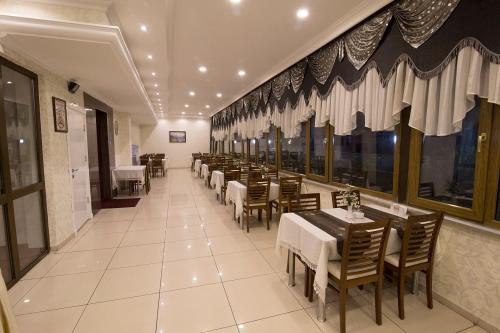 a dining room with tables and chairs in a restaurant at Ceylan Hotel in Bursa