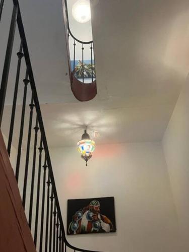 a staircase with a light and a picture of a football player at Belle maison Centre Sérignan in Sérignan
