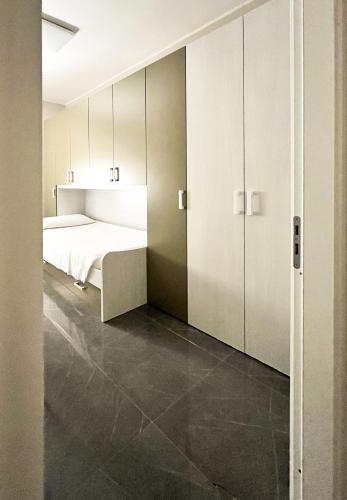a bedroom with a bed and white cabinets at The Superhost - Casa Grande in Crotone