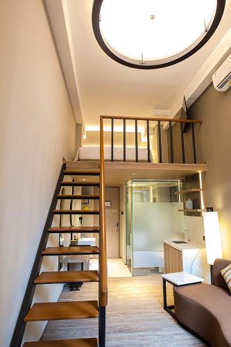 a room with a loft bed and a living room at Posto Dormire Sudirman in Jakarta