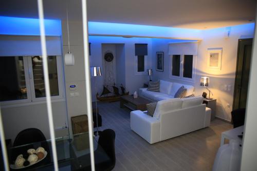 a living room with two white couches and a blue light at Lefkada Beach Villa in Lefkada Town