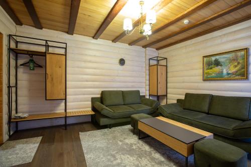a living room with two couches and a table at Korona Hotel&SPA in Bukovel