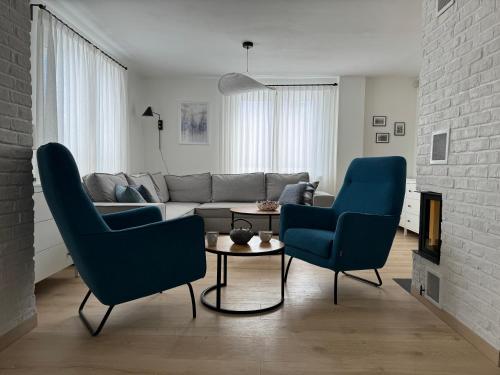 a living room with two blue chairs and a couch at 611 n.p.m. in Jelenia Góra-Jagniątków