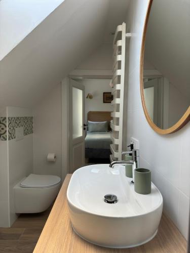 a bathroom with a white sink and a mirror at 611 n.p.m. in Jelenia Góra-Jagniątków