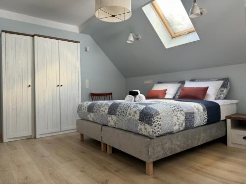 a bedroom with a large bed and a skylight at 611 n.p.m. in Jelenia Góra-Jagniątków