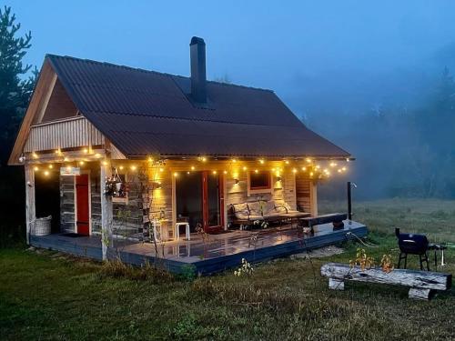 a small house with lights on it in a field at Kakerdaja Private Sauna in Vose