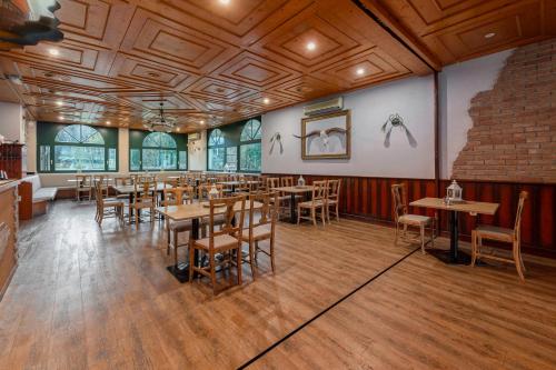 a dining room with wooden tables and chairs at Hotel Burger Veniše in Rečica ob Savinji